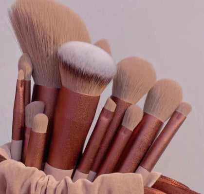 13Pcs makeup brush set in rose gold with dense synthetic bristles, ideal for foundation, highlighter, and eye makeup application.