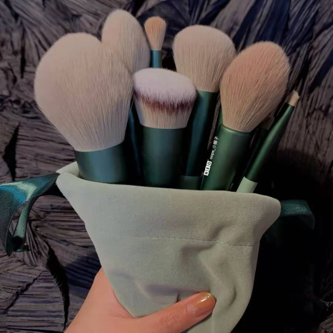 13Pcs Makeup Brush Set in green with soft synthetic bristles in a drawstring pouch, perfect for full-face makeup application and blending.